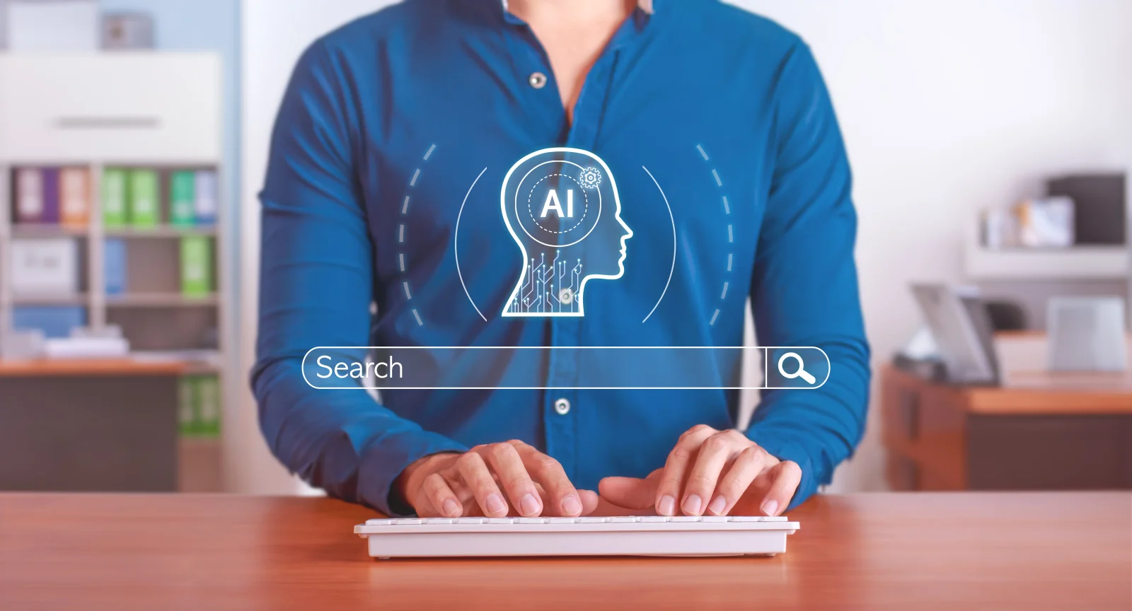 Person typing at a keyboard beneath a glowing search bar and an AI head icon in an office Person typing at a keyboard beneath a glowing search bar and an AI head icon in an office