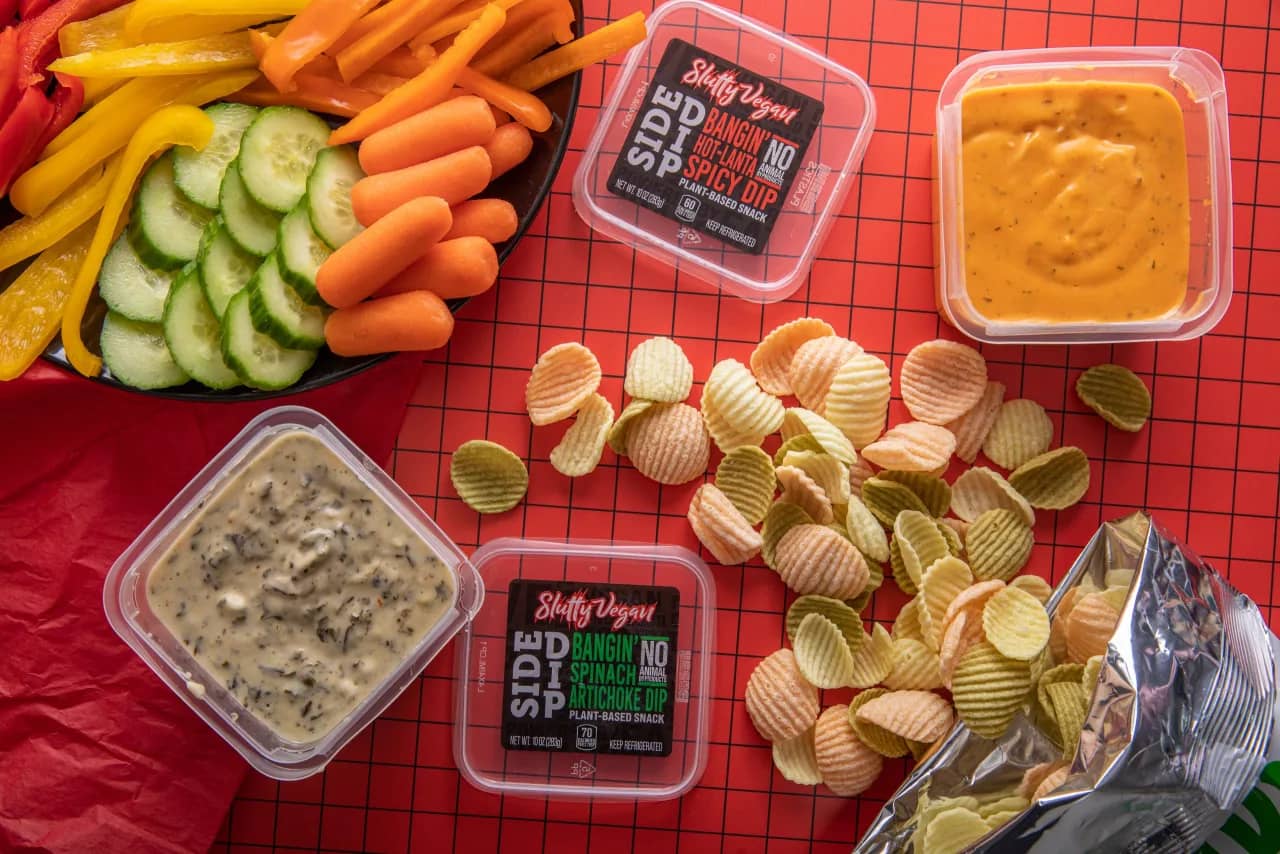 Brand and product content, Slutty Vegan Slutty Vegan branded dips photographed with fresh vegetables and chips on a red background, brand content produced by Sierra Media Productions.